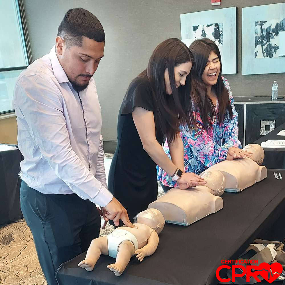 CPR training class in Las Vegas with students practicing on mannequins.